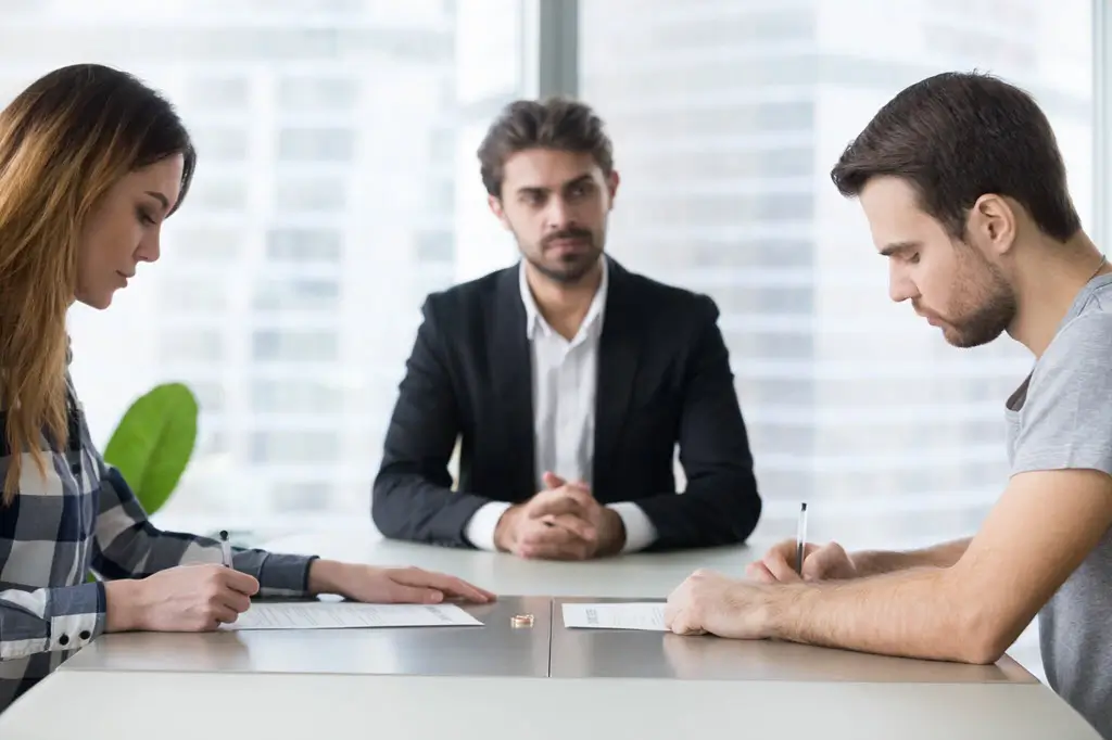 Couple with family law arbitrator at table